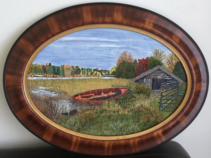 Oval framed painting of a serene landscape with an abandoned red boat by a grassy lake. A small wooden shed stands nearby under a sky with soft clouds. Trees with autumn foliage line the horizon, creating a peaceful scene.