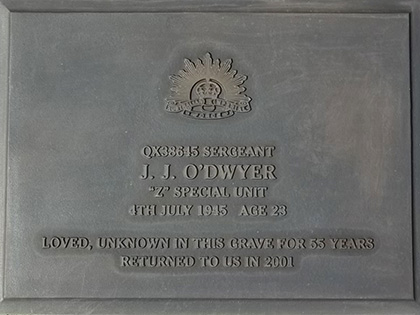 A commemorative plaque for Sergeant J.J. O'Dwyer of the "Z" Special Unit, born 4th July 1915, died at age 23. Inscription notes his unknown grave for 55 years and return in 2001. Features an engraved rising sun emblem.