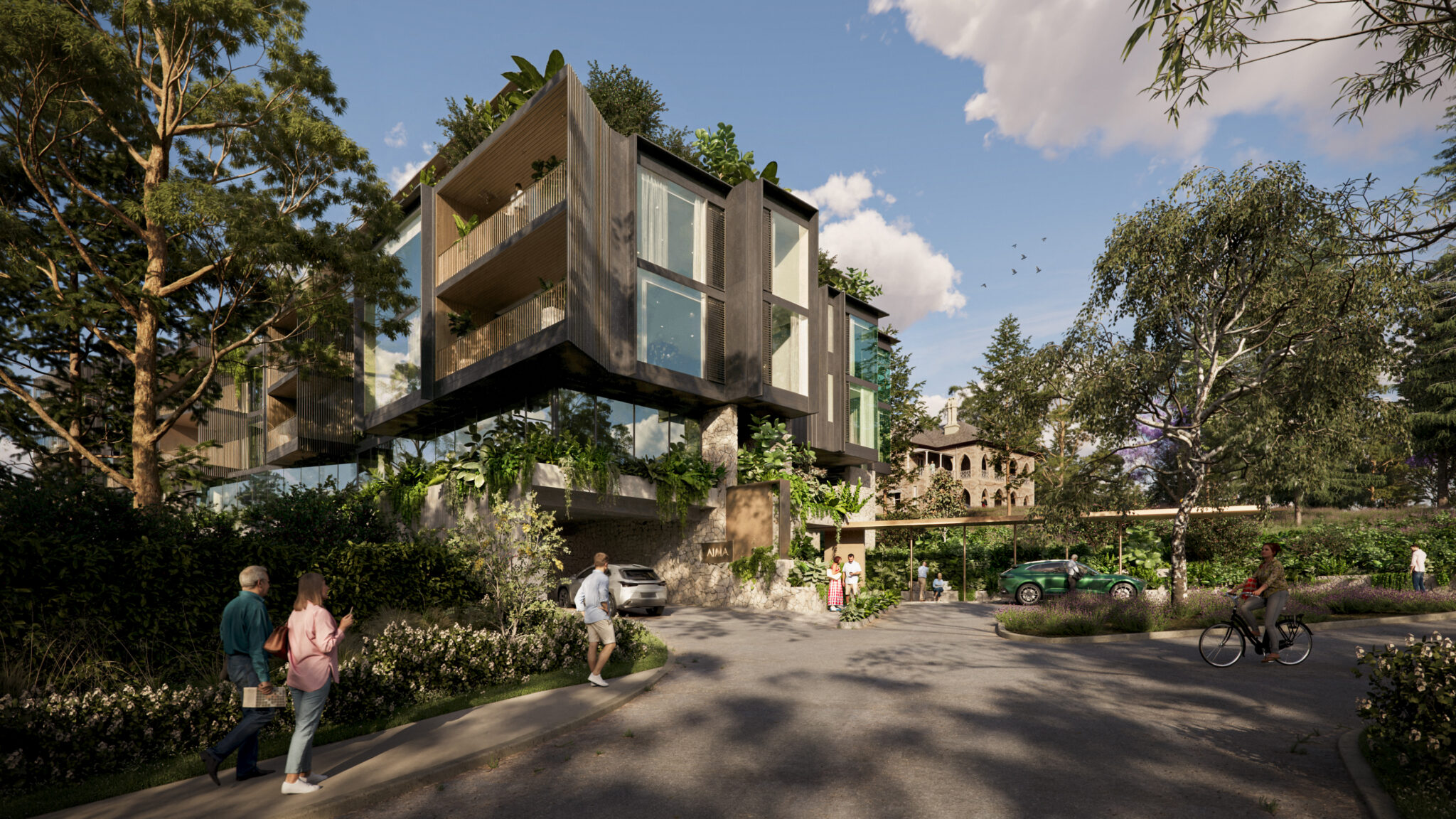 Modern building with large glass windows and balconies covered in greenery, surrounded by trees. People walk and cycle on a curved driveway, and cars are parked nearby under a carport. The sky is partly cloudy.